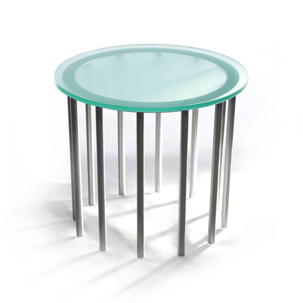 Duplicator table uses rhythmic steel rods to support its thick etched glass top. It makes a striking and modern statement in any reception area as a side table or for display.  Shown with round glass top and twelve silver legs.