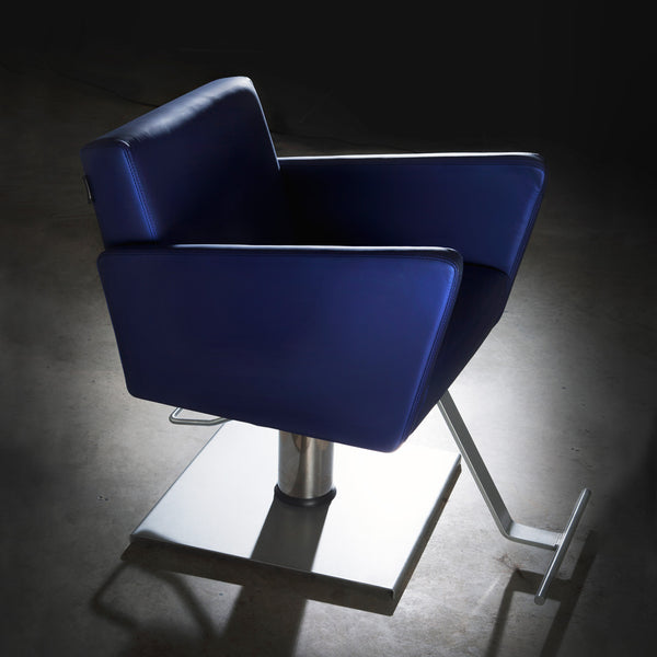 Detailed picture of a Facet salon chair in blue upholstery with a silver foot rest and square pump base.