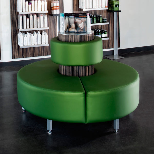 Concentric reception bench offers three hundred sixty degrees of style and function for you and your guests.  Shown in green synthetic leather with silver legs and a wood veneer center column.