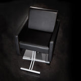 Cutter salon chair shown in black upholstery with a silver square pump base.
