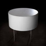 Cylindrical upholstered retail table.  Shown in white synthetic leather with contrasting silver legs.
