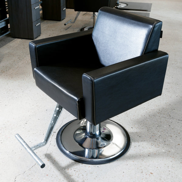 Club is a high end fully upholstered lounge type styling chair constructed in hard wood ply for durability.  All cushions are high resilient foam with a heavy saddle stitched synthetic rawhide leather cover. Shown in black upholstery with chrome and a round base.